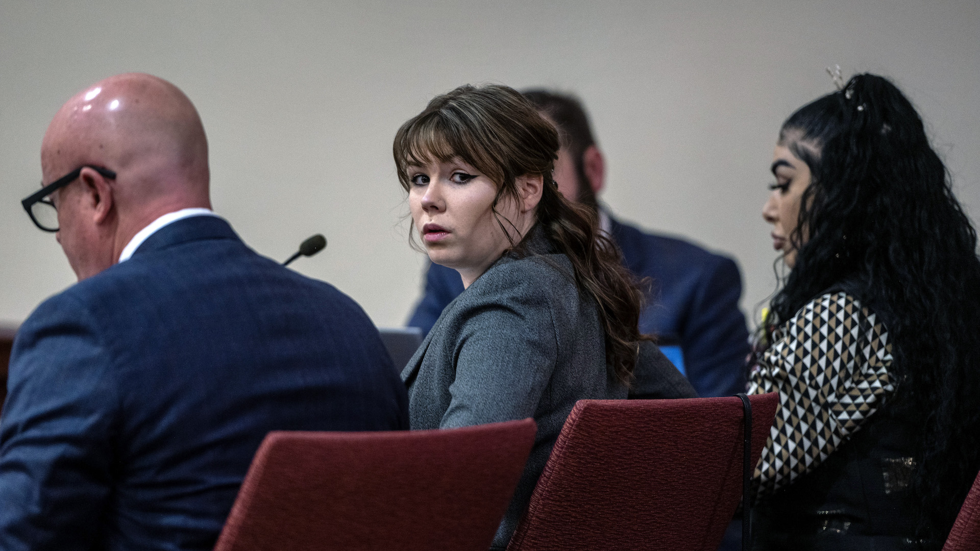 Hannah Gutierrez-Reed, center, sits with her attorney Jason Bowles, left, during the first day of testimony in the trial against her in First District Court, in Santa Fe, N.M., Thursday, February 22, 2024. Gutierrez-Reed, who was working as the armorer on the movie 
