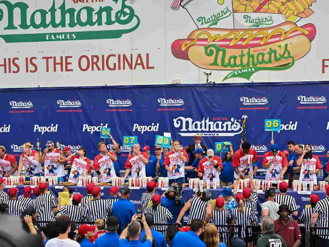 Men compete during the 2023 Nathan's Famous Fourth of July International Hot Dog Eating Contest.